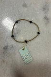 E Newton Signature Cross Small Gold Pattern 2mm Bead Bracelet Charcoal